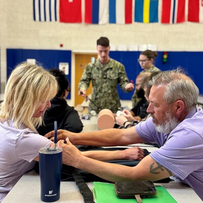 SIGONELLA, Italy (April 16, 2025) — Hospital Corpsman 2nd Class Connor Hepker, assigned to U.S. Naval Hospital (USNH) Sigonella instructs DoDEA educators on proper tourniquet application during a recent "Stop the Bleed" course, April 16, 2025. The course provided 25 DoDEA Sigonella schoolteachers with critical, hands-on training to control life-threatening bleeding in emergency situations. Stop the Bleed is a Department of Defense (DoD) initiative that empowers individuals with the knowledge and skills to save lives before professional help arrives. (U.S. Navy photo by Chiara Caputo).