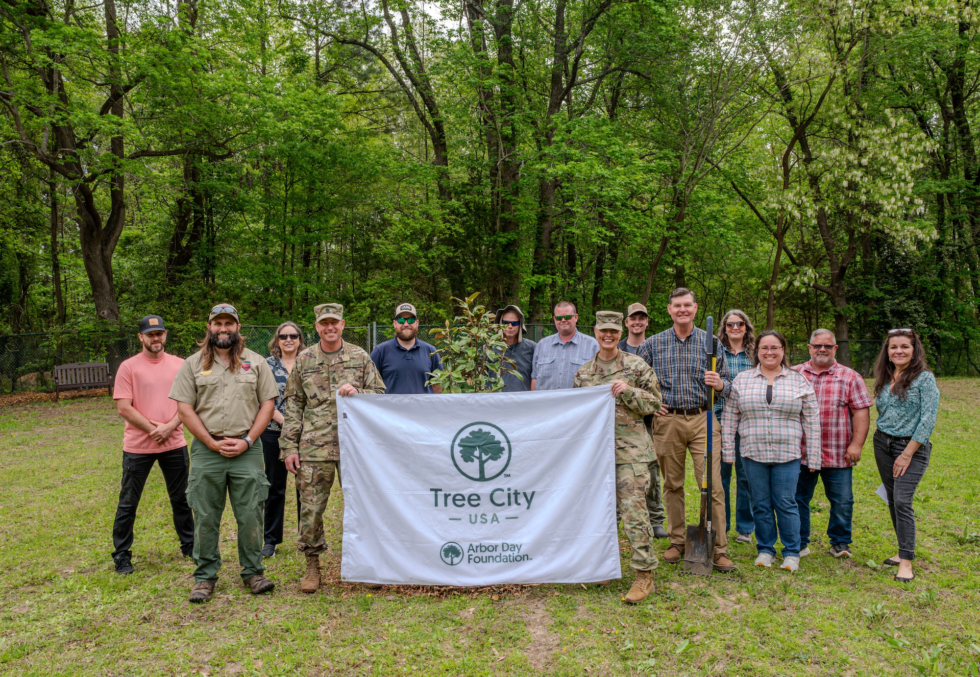 Army Col. Laura Hutchinson and Command Sgt. Maj. Jarred Matthews along with members of the 733d Civil Engineer Squadron pose for a group photo at JBLE
