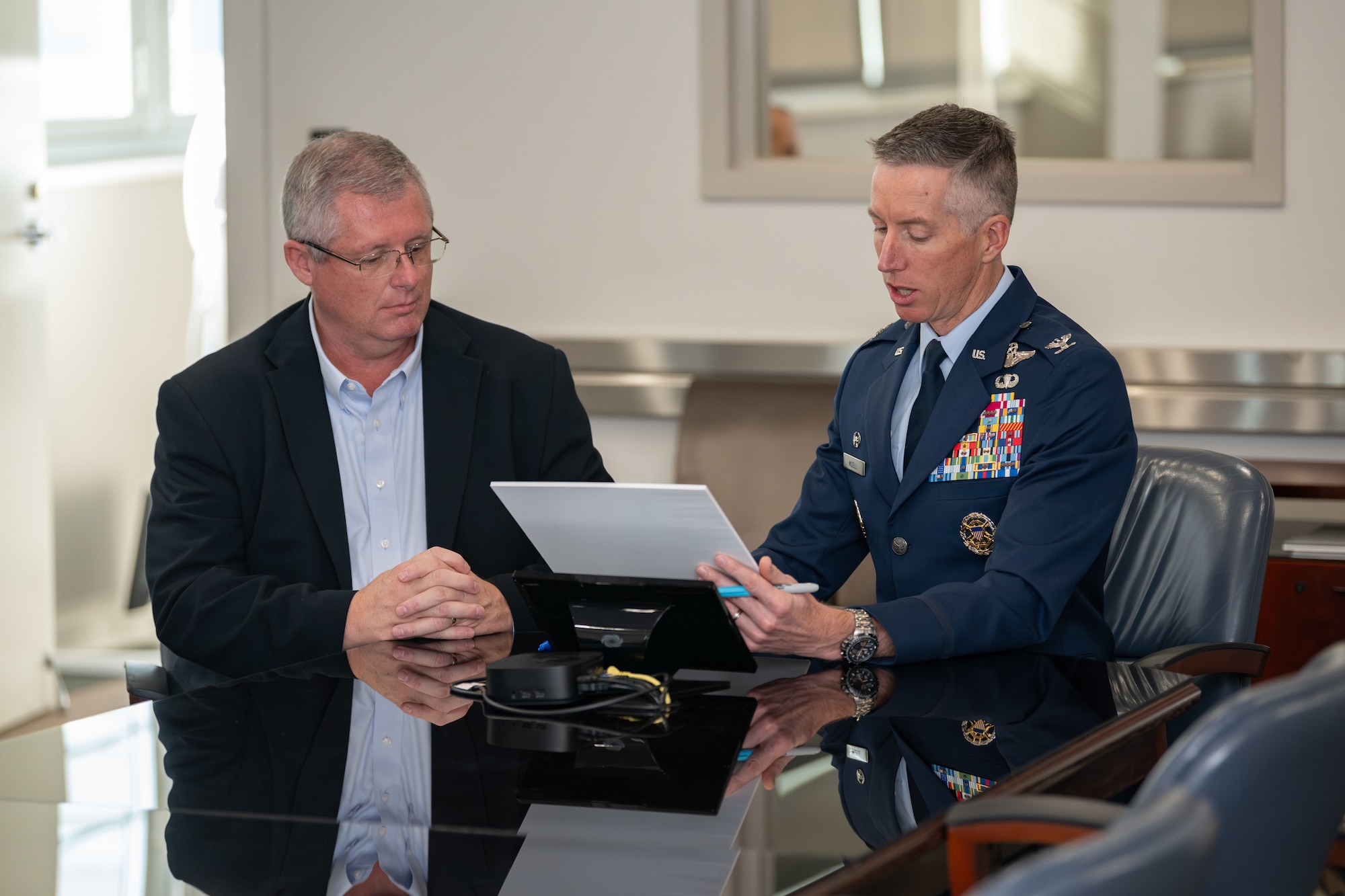 Arnold Engineering Development Complex Commander Col. Grant Mizell, right, reads from a proclamation March 28, 2025, recognizing April as Sexual Assault Awareness and Prevention Month across AEDC. Mizell signed the proclamation in his conference room at Arnold Air Force Base, Tenn., headquarters of AEDC. Pictured with Mizell is Gary Johnson, sexual assault response coordinator at Arnold AFB. (U.S. Air Force photo by Keith Thornburgh)