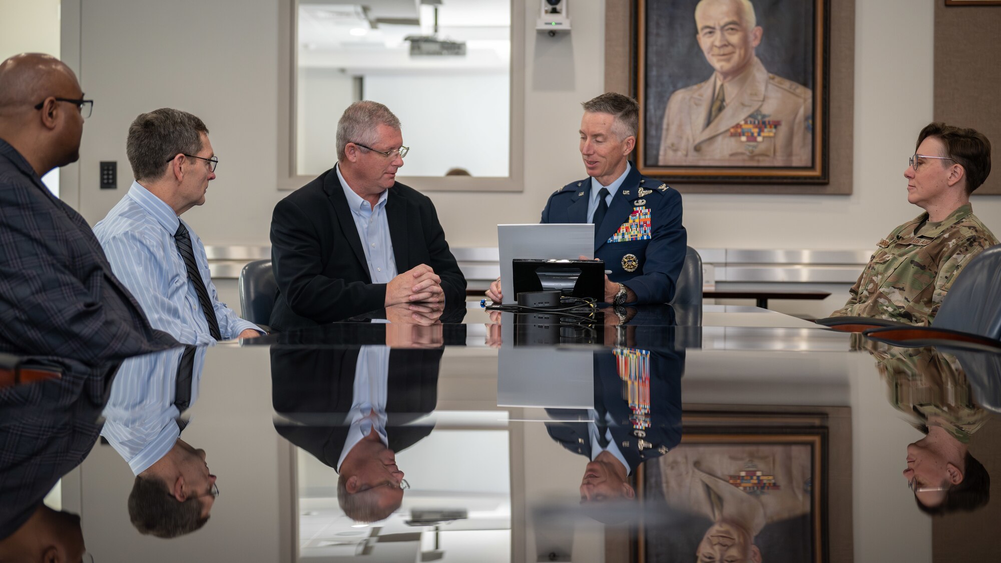 Arnold Engineering Development Complex Commander Col. Grant Mizell, second from right, is surrounded by AEDC leadership and the heads of the Integrated Prevention and Response and Sexual Assault Prevention and Response offices at Arnold Air Force Base, Tenn., as he reads from a proclamation March 28, 2025, recognizing April as Sexual Assault Awareness and Prevention Month across AEDC. Mizell signed the proclamation in his conference room at Arnold AFB, headquarters of AEDC. Pictured with Mizell, from left, are Integrated Prevention and Response Director Lee Smith, AEDC Deputy Director Kevin Muckerheide, Sexual Assault Response Coordinator Gary Johnson and AEDC Senior Enlisted Leader Chief Master Sgt. Jennifer Cirricione. (U.S. Air Force photo by Keith Thornburgh)