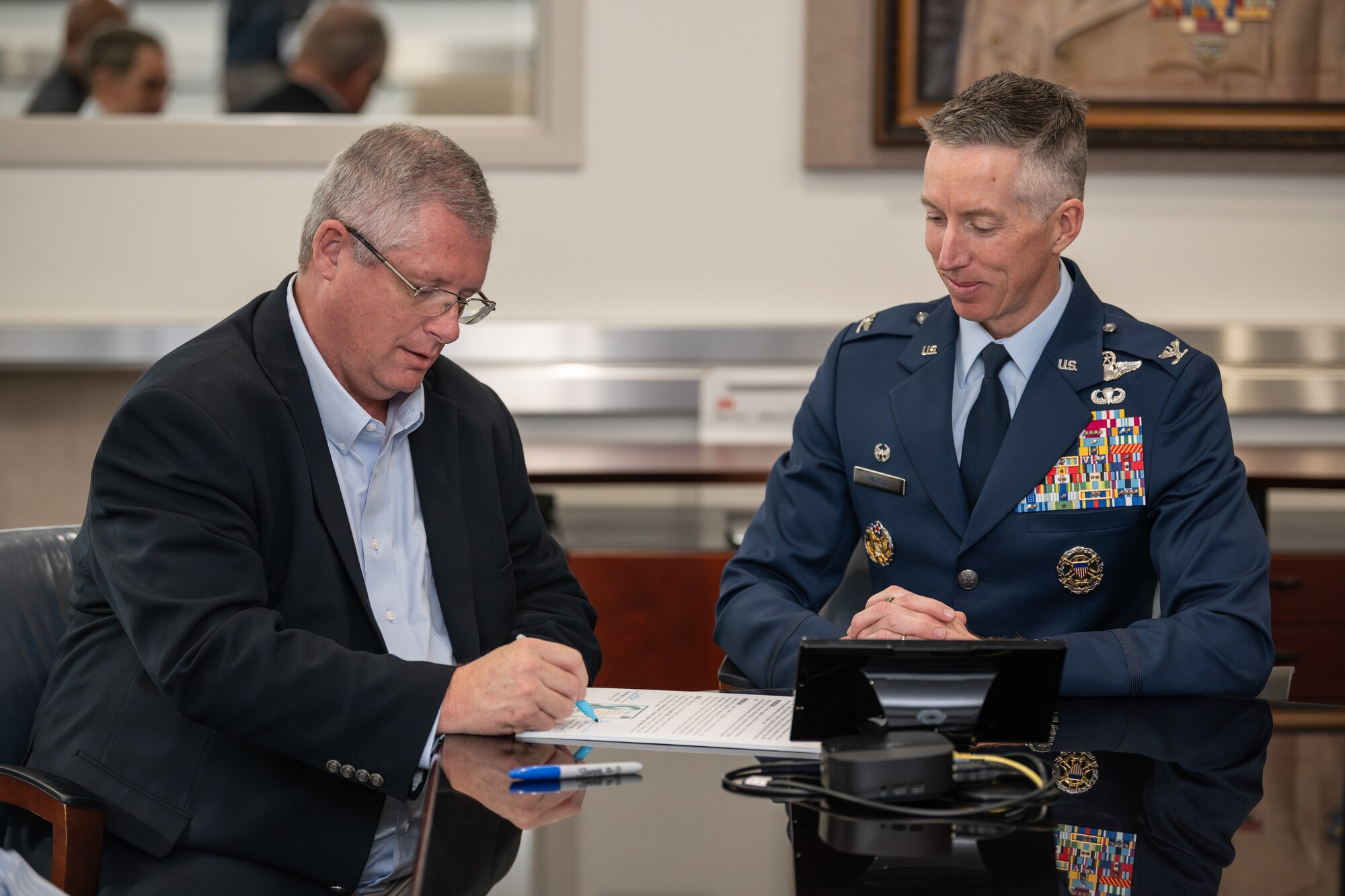 Arnold Engineering Development Complex Commander Col. Grant Mizell, right, looks on as Gary Johnson, sexual assault response coordinator at Arnold Air Force Base, Tenn., signs a proclamation March 28, 2025, recognizing April as Sexual Assault Awareness and Prevention Month across AEDC. Mizell signed the proclamation prior to Johnson. Arnold AFB is the headquarters of AEDC. (U.S. Air Force photo by Keith Thornburgh)