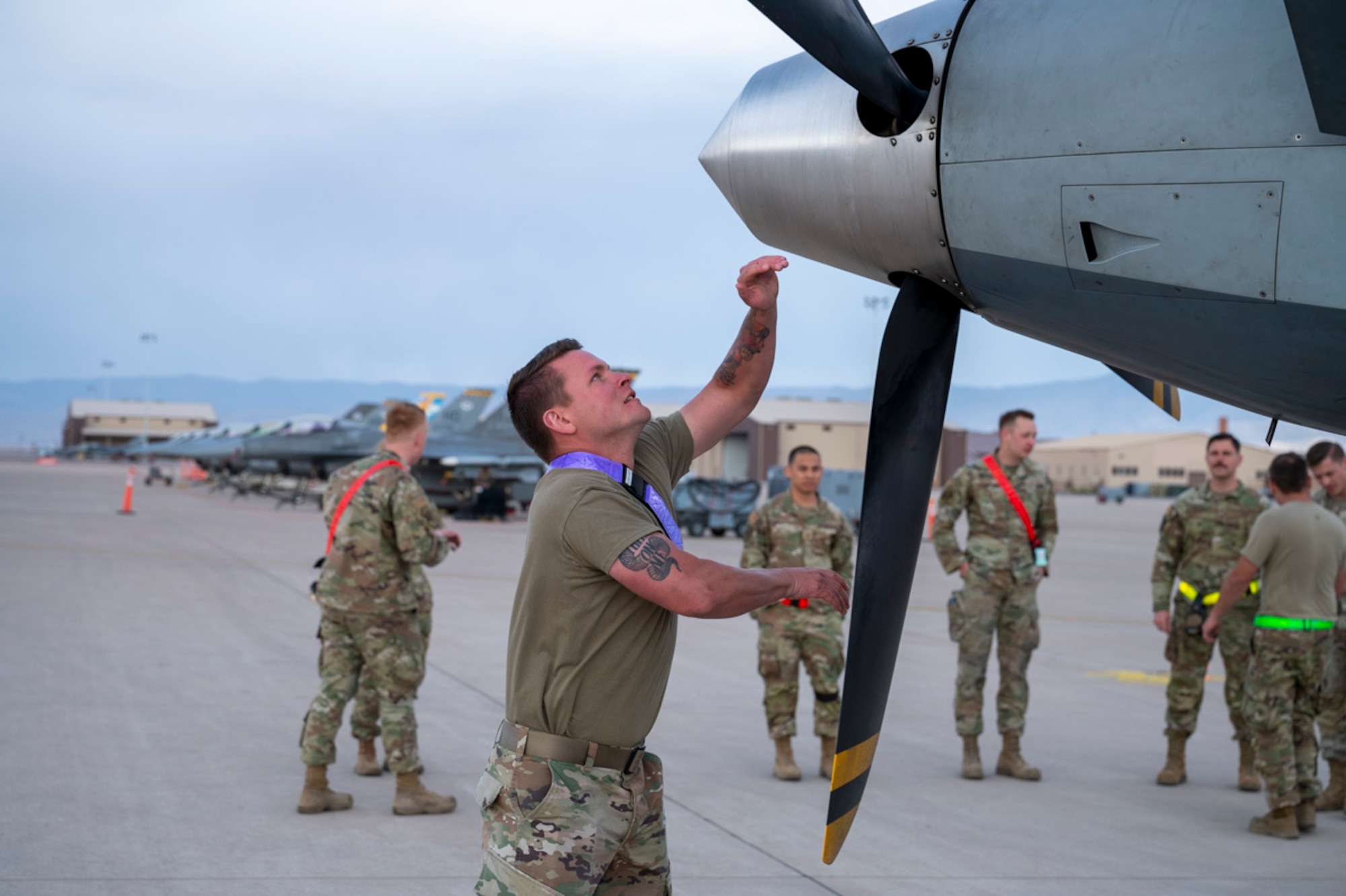 U.S. Air Force Staff Sgt. Hugh Staff, 49th Aircraft Maintenance Unit MQ-9 avionics system craftsman, rotates an MQ-9 Reaper propeller at Holloman Air Force Base, New Mexico, April 3, 2025. By combining the strengths of F-16 Fighting Falcons and MQ-9s, Project Iron Agility showcases seamless multi-platform integration for enhanced flexibility and mission capability. (U.S. Air Force photo by Senior Airman Michelle Ferrari)