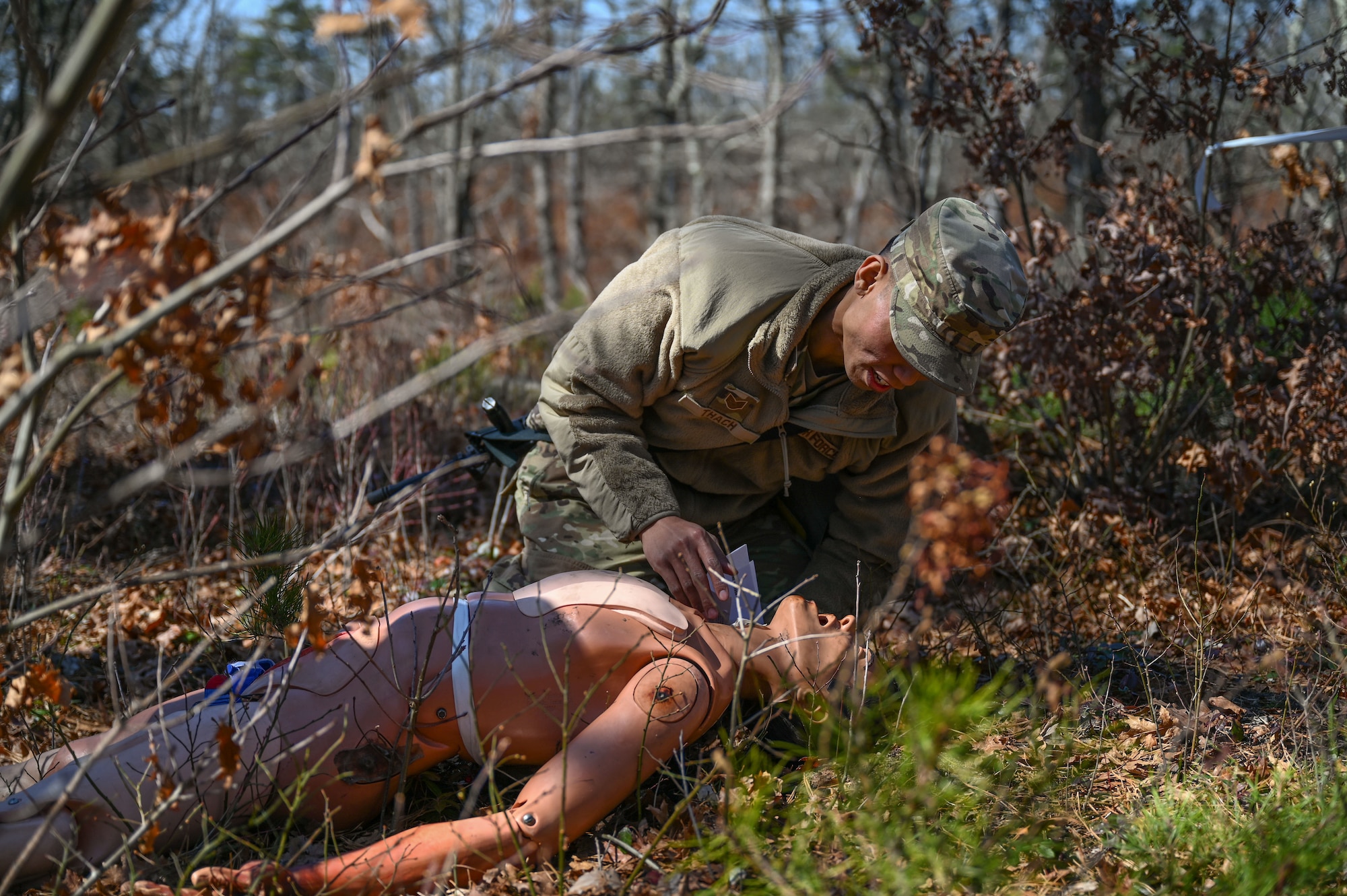 Airman checks airway of a manikin.