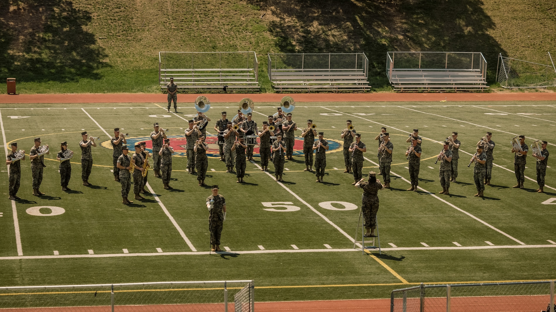 U.S. Marines assigned to Quantico Marine Corps Band perform at Butler Stadium on MCB Quantico, April 18, 2025. The band provides musical support that encourages community relations, enhances troop morale, and promotes the Marine Corps. (U.S. Marine Corps photo by Lance Cpl. Harleigh Faulk)