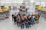 Personnel from the Fleet Readiness Center Southeast (FRCSE) F-35 aircraft production line stand in front of a recently inducted F-35B Lightning II that was recently delivered from Marine Fighter Attack Squadron 122 at Yuma, Ariz. The jet is the first F-35 ever inducted into the depot and is part of a readiness improvement initiative to support corrosion mitigation efforts for the U.S. Marine Corps (USMC).