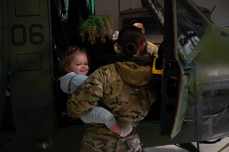 Team Minot families get a tour of a UH-1N Iroquois at Minot Air Force Base, North Dakota, April 18, 2025. Families were given the opportunity to tour the base in honor of the Month of the Military Child. (U.S. Air Force photo by Senior Airman Alyssa Bankston)