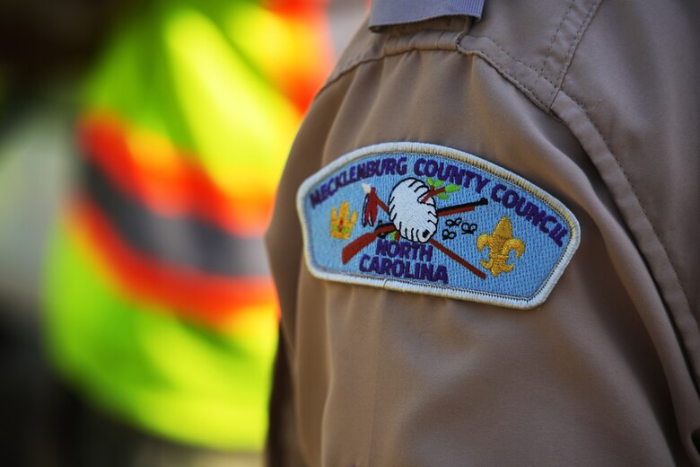 A patch from the Mecklenburg Scout Reservation's Camp Grimes is seen on the uniform of Camp Ranger Troy Williams in McDowell County, North Carolina, April 18, 2025. Williams oversees the 1,100-acre Boy Scout camp, which is receiving debris removal support from the U.S. Army Corps of Engineers following Hurricane Helene. The work is helping prepare the camp to safely reopen for the summer season.