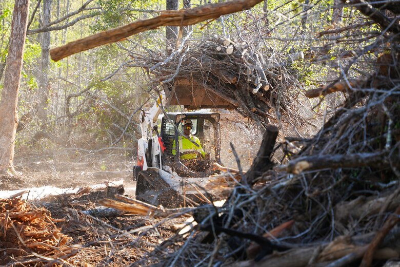Contractors working under the direction of the U.S. Army Corps of Engineers clear storm debris from Hurricane Helene at the Boy Scouts of America's Camp Grimes in McDowell County, North Carolina, April 18, 2025. The removal effort is part of a FEMA-assigned mission to assist with private property debris removal. The work is helping prepare the 1,100-acre Boy Scout camp to reopen for summer programs.