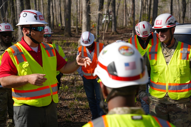 Mark Cardwell, U.S. Army Corps of Engineers private property debris removal mission manager (left), briefs USACE senior leadership on the progress being made in McDowell County, during a visit to a local boy scout camp receiving debris removal assistance, April 25, 2025. The PPDR program allows property owners to apply to have qualifying debris caused by Hurricane Helene removed from their property by the Corps of Engineers.