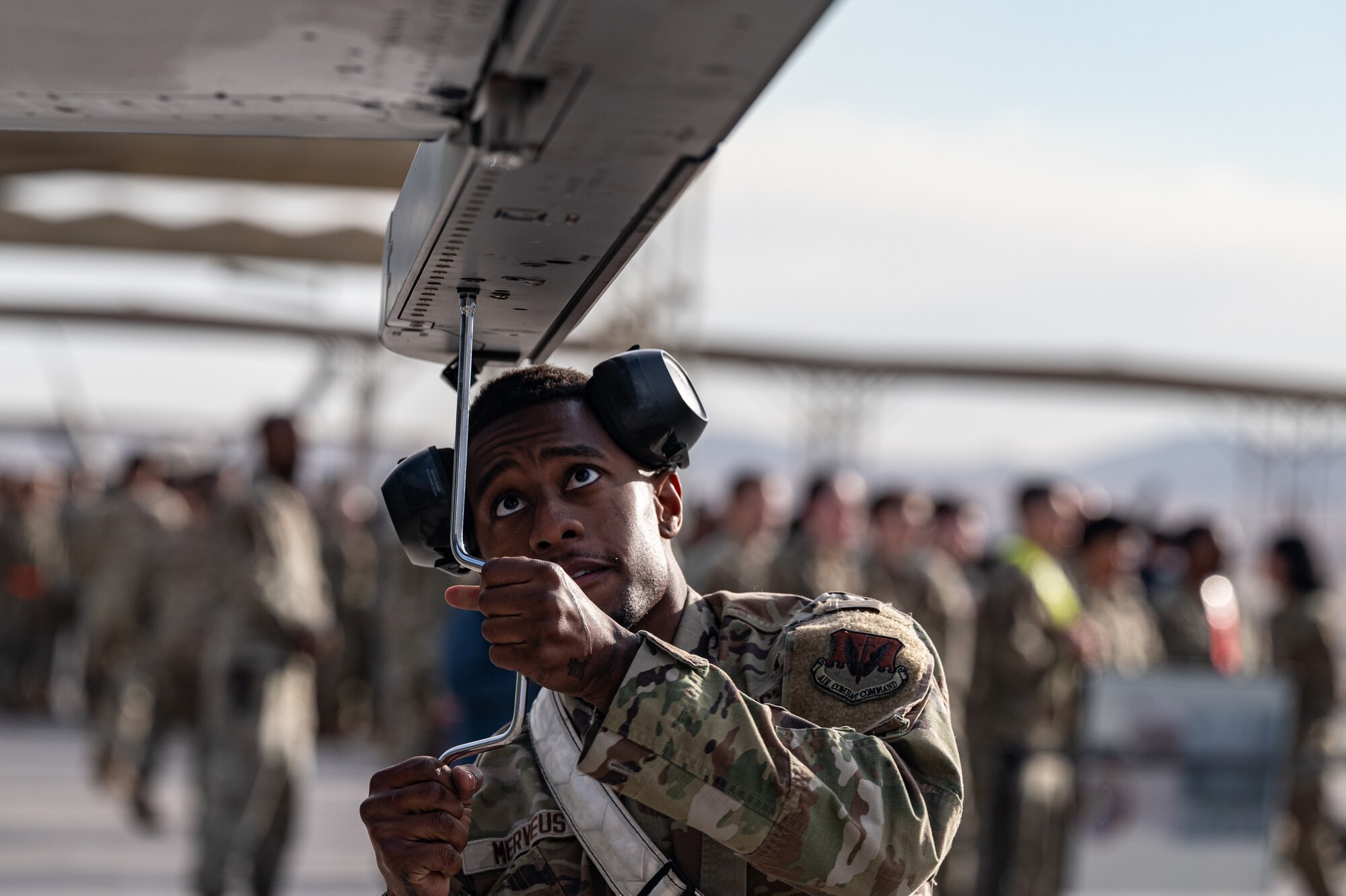 U.S. Air Force Senior Airman Frantz Merveus, a 57th Aircraft Maintenance Squadron weapons load team member, tightens a bolt during the first quarter weapons standardization load crew competition at Nellis Air Force Base, Nevada, April 18, 2025.