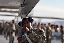 U.S. Air Force Senior Airman Frantz Merveus, a 57th Aircraft Maintenance Squadron weapons load team member, tightens a bolt during the first quarter weapons standardization load crew competition at Nellis Air Force Base, Nevada, April 18, 2025.
