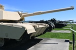 Tanks on display in a field.