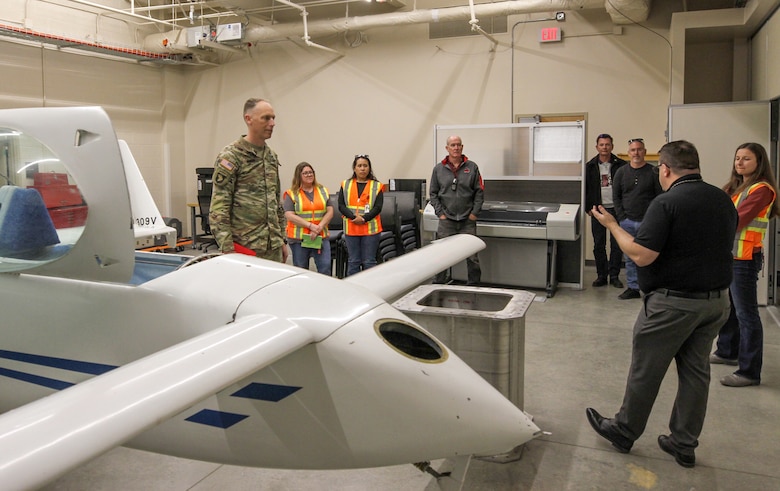 Jason Bostjancic, 412th Test Engineering Group deputy director, second from right, talks with Col. Andrew Baker, U.S. Army Corps of Engineers Los Angeles District commander, left, about the technical features of the Flight Test Engineering Laboratory during Baker’s April 3 visit to Edwards Air Force Base, California. The LA District designed and constructed the two-story, 75,000-square-foot laboratory, engineering and office complex for the Air Force.