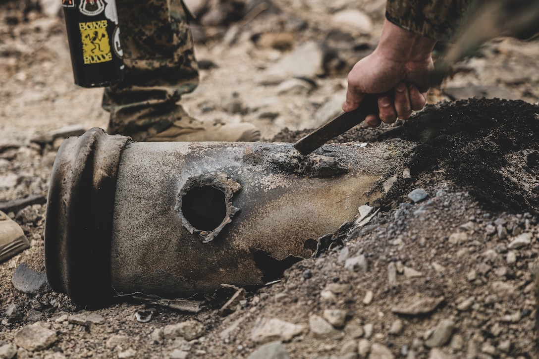 U.S. Marine Corps explosive ordnance disposal technicians from across the Corps observe the aftermath of a controlled explosion on an empty Mk-82 bomb during controlled ordnance disposal training at Range 112, Marine Corps Air-Ground Combat Center, Twentynine Palms, California, March 5, 2025. This course, provided at the EOD Advanced Training Center, is the only course for EOD technicians to develop their skills and capabilities as EOD Response Element Leaders. They are taught to properly employ various techniques and planning considerations in accordance with EOD orders, doctrines, and publications in support of various missions across multiple domains. (U.S. Marine Corps photo by Lance Cpl. Richard PerezGarcia)