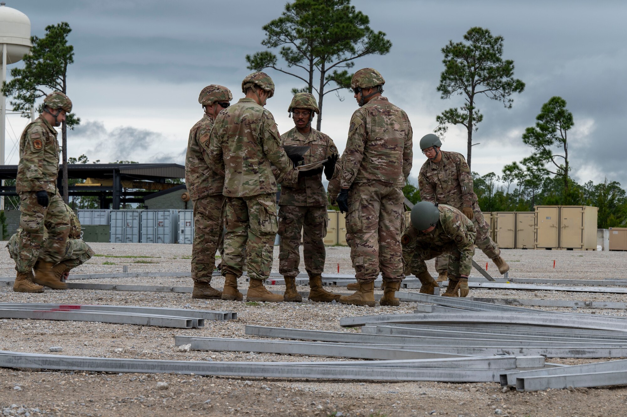 U.S. Air Force Airmen assigned to the 22nd Air Task Force discuss how to build an Alaska Small Shelter System during a Silver Flag exercise at Tyndall Air Force Base, Florida, April 7, 2025. This field training exercise tested the 22nd ATF’s capacity to operate under duress, ensuring a highly trained and adaptable force prepared for the complexities of modern warfare. (U.S. photo by Airman 1st Class Samantha Thorn)