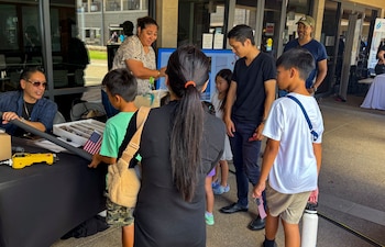 KAPOLEI, Hawaii (April 5, 2025) Mario Maningas, physical scientist, Navy Closure Task Force-Red Hill (NCTF-RH) and Tiffany Iiga-Saole, deputy assistant regional engineer, Commander, Navy Region Hawaii (CNRH),  speak with guests at the ninth annual Onizuka Day of Exploration held at the University of Hawaii-West Oahu in Kapolei, Hawaii, April 5, 2025. The local science, technology, engineering and mathematics (STEM) event provided an opportunity for the local community to engage with NCTF-RH and CNRH members to learn about STEM-related operations as part of their mission to safely close the Red Hill Bulk Fuel Storage Facility.  (U.S. Navy photo by Lt. Naadia Puri)