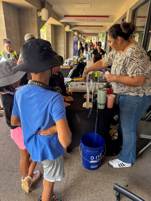 KAPOLEI, Hawaii (April 5, 2025) Tiffany Iiga-Saole, deputy assistant regional engineer, Commander, Navy Region Hawaii (CNRH), demonstrates ground water flow monitoring at the ninth annual Onizuka Day of Exploration held at the University of Hawaii-West Oahu in Kapolei, Hawaii, April 5, 2025. The local science, technology, engineering and mathematics (STEM) event provided an opportunity for the local community to engage with NCTF-RH and CNRH members to learn about NCTF-RH STEM-related operations as part of their mission to safely close the Red Hill Bulk Fuel Storage Facility.  (U.S. Navy photo by Lt. Naadia Puri)