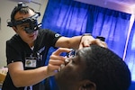 U.S. Air Force Maj. Samuel Hobbs, 59th Medical Wing vitreoretinal surgeon, assesses a patient at Georgetown Public Hospital, Georgetown, Guyana, April 3, 2025 during the Lesser Antilles Medical Assistance Team (LAMAT) 2025 mission.