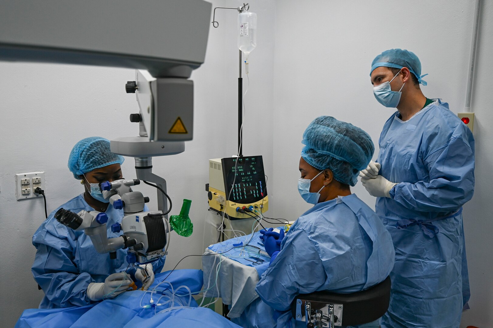 Dr. Arlene Bobb-Semple, Georgetown Public Hospital vitreoretinal surgeon performs a procedure with guidance from U.S. Air Force Maj. Samuel Hobbs, 59th Medical Wing vitreoretinal surgeon (right), at Georgetown, Guyana, April 3, 2025 during the Lesser Antilles Medical Assistance Team (LAMAT) 2025 mission.