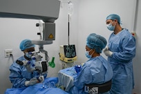 Dr. Arlene Bobb-Semple, Georgetown Public Hospital vitreoretinal surgeon performs a procedure with guidance from U.S. Air Force Maj. Samuel Hobbs, 59th Medical Wing vitreoretinal surgeon (right), at Georgetown, Guyana, April 3, 2025 during the Lesser Antilles Medical Assistance Team (LAMAT) 2025 mission.