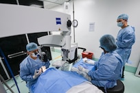 U.S. Army Maj. Sien Chen, Brooke Army Medical Center cataract eye surgeon, and U.S. Air Force Maj. Samuel Hobbs, 59th Medical Wing vitreoretinal surgeon (right), collaborate during a procedure at Georgetown Public Hospital, Guyana, April 3, 2025 during the Lesser Antilles Medical Assistance Team (LAMAT) 2025 mission.