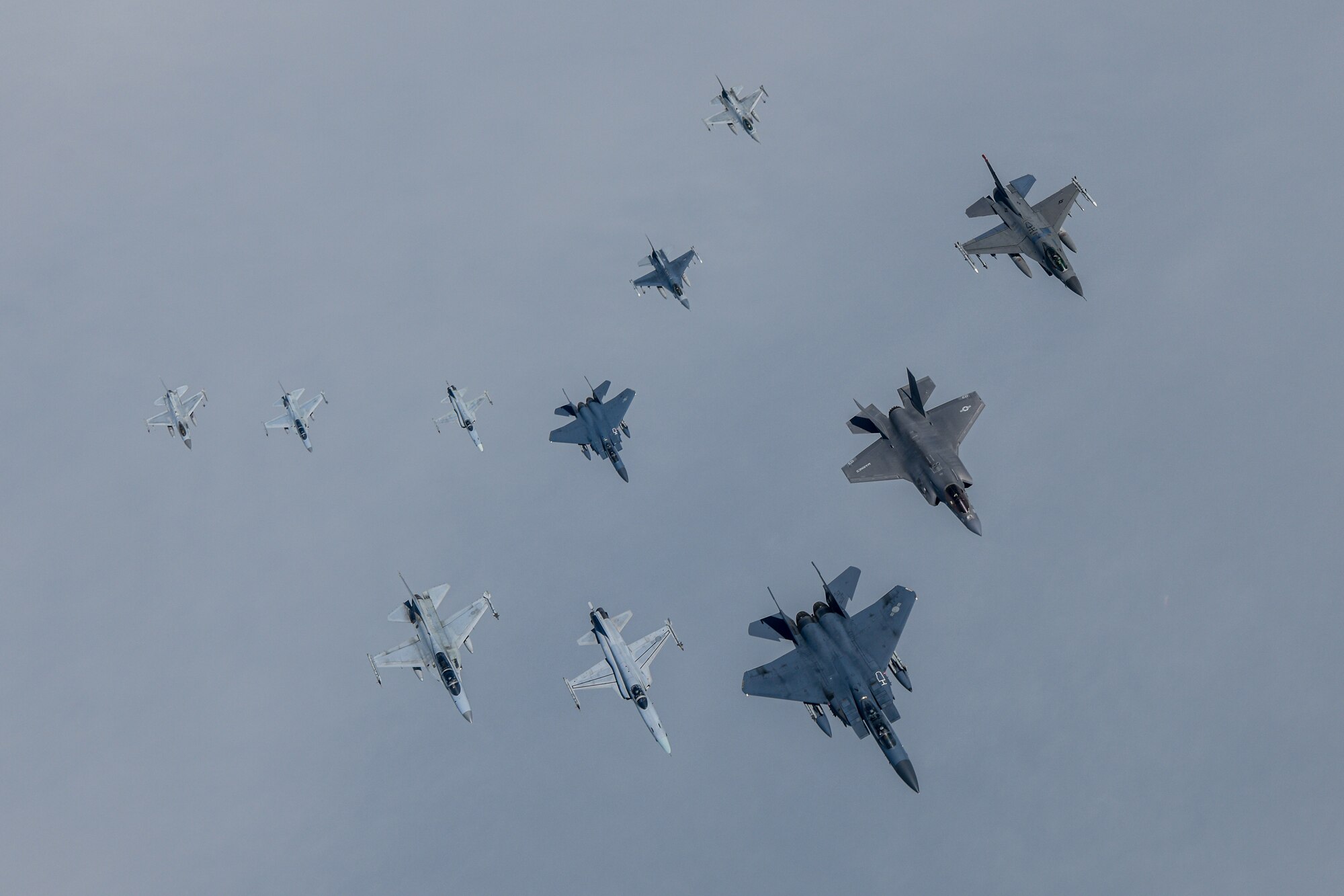 U.S. and Republic of Korea military aircraft fly in formation.  From left in the front row: ROK FA-50, F-5, KF-15 Slam Eagle, U.S. F-35B Lightning II and F-16 Fighting Falcon. From left in the back row: ROK KF-16, FA-50, F-5, F-15K, U.S. F-16 and ROK F-16.