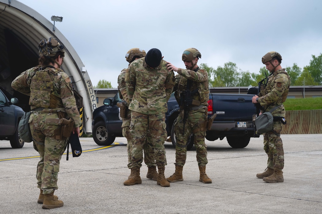 Defenders assigned to the 52nd Security Forces Squadron detain a simulated malicious actor during an insider threat scenario involving an F-16 Fighting Falcon as part of Exercise Swift Saber 25 at Spangdahlem Air Base, Germany, April 22, 2025. The scenario validated the defenders’ ability to respond to insider threats and minimize their impact on 52nd Fighter Wing assets. Exercises like Swift Saber 25 strengthen the 52nd FW’s warfighting capabilities by validating Agile Combat Employment concepts, including rapid threat response, dispersed operations and mission generation in contested environments. (U.S. Air Force photo by Senior Airman Darius Frazier)