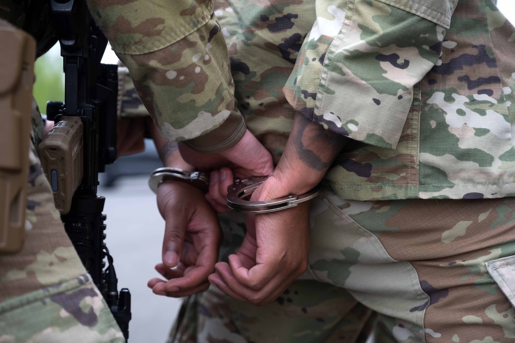 A defender assigned to the 52nd Security Forces Squadron detains a simulated malicious actor during an insider threat scenario involving an F-16 Fighting Falcon as part of Exercise Swift Saber 25 at Spangdahlem Air Base, Germany, April 22, 2025. Scenarios throughout the combat readiness exercise tested 52nd SFS defenders on their ability to respond to a range of threats and situations. Exercises like Swift Saber 25 enhance the 52nd Fighter Wing’s warfighting capabilities by validating Agile Combat Employment concepts such as rapid threat response, dispersed operations and mission generation in contested environments. (U.S. Air Force photo by Senior Airman Darius Frazier)