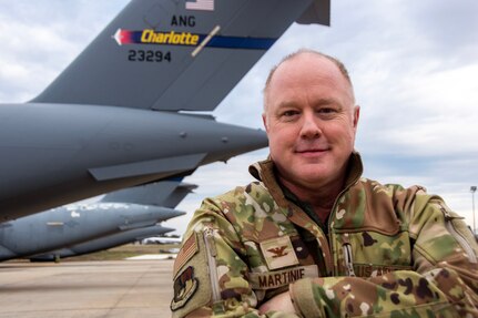 U.S. Air Force Col. Daniel Martinie, North Carolina Joint Force Headquarters-Air, State Air Surgeon poses for a photo on the flightline at Charlotte-Douglas International Airport base, March 8, 2025.