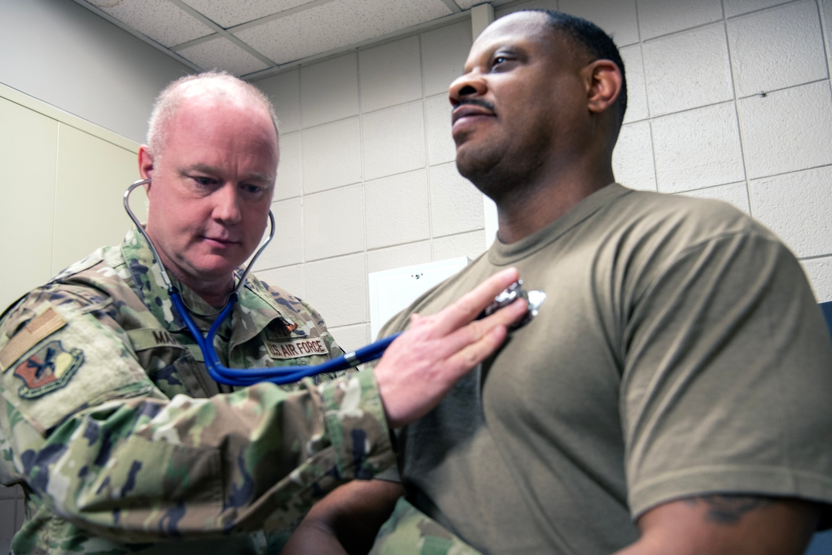 U.S. Air Force Col. Daniel Martinie, North Carolina Joint Force Headquarters-Air, State Air Surgeon and Staff Sgt. Idris cates, 145th Medical Group, medical technician pose for a photo in an exam room at Charlotte-Douglas International Airport base, March 8, 2025.