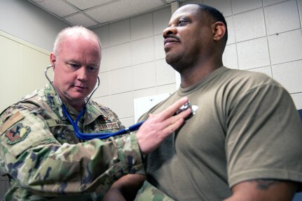 U.S. Air Force Col. Daniel Martinie, North Carolina Joint Force Headquarters-Air, State Air Surgeon and Staff Sgt. Idris cates, 145th Medical Group, medical technician pose for a photo in an exam room at Charlotte-Douglas International Airport base, March 8, 2025.