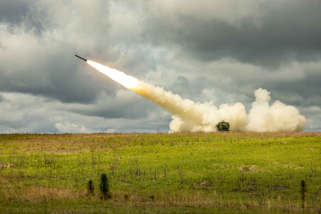 A U.S. Marine Corps High Mobility Artillery Rocket System with 2d Battalion, 10th Marine Regiment, 2d Marine Division fires a rocket on a live-fire range during exercise Rolling Thunder on Fort Bragg, North Carolina, April 11, 2025. This live-fire artillery exercise tested 10th Marine Regiment’s command-and-control, indirect fire support, counter-fire operations, and sensor operations in a simulated littoral environment against a future threat. (U.S. Marine Corps photo by Lance Cpl. Judith Ann Lazaro)