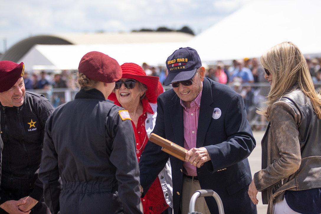 Samuel Benjamin Hollis, U.S. Army retired, receives the Golden Knights wooden baton during the 2025 Beaufort Air Show at Marine Corps Air Station Beaufort, South Carolina, April 12, 2025. Hollis, a proud World War II veteran, is celebrating a remarkable milestone this year—his 100th birthday. Born in 1925 in the small town of Mayfield, Georgia, Samuel, affectionately known as “Bennie” in his youth, was drafted into the U.S. Armed Forces at just 17, shortly after graduating from high school. (U.S. Marine Corps photo by Lance Cpl. Julius Hackney)