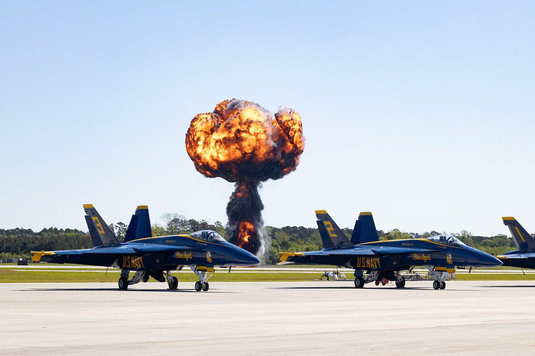 A pyrotechnic display, is triggered behind the Blue Angels aircraft number 6 by Explosive Ordnance Disposal (EOD) technicians and Marine Air-Ground Task Force Demonstration Team during the 2025 Beaufort Airshow at Marine Corps Air Station Beaufort, South Carolina, April 13, 2025. The MAGTF is combined of four elements—Command Element, Ground Combat Element, Aviation Combat Element and Logistics Combat Element—that work seamlessly together. Within days, a MAGTF can be anywhere in the world and arrive ready to accomplish its mission. The MAGTF is the ideal rapid response team, able to quickly answer the call of duty, whatever it may be, wherever it may take them. (U.S. Marine Corps photo by Lance Cpl. Isabella Renaud)