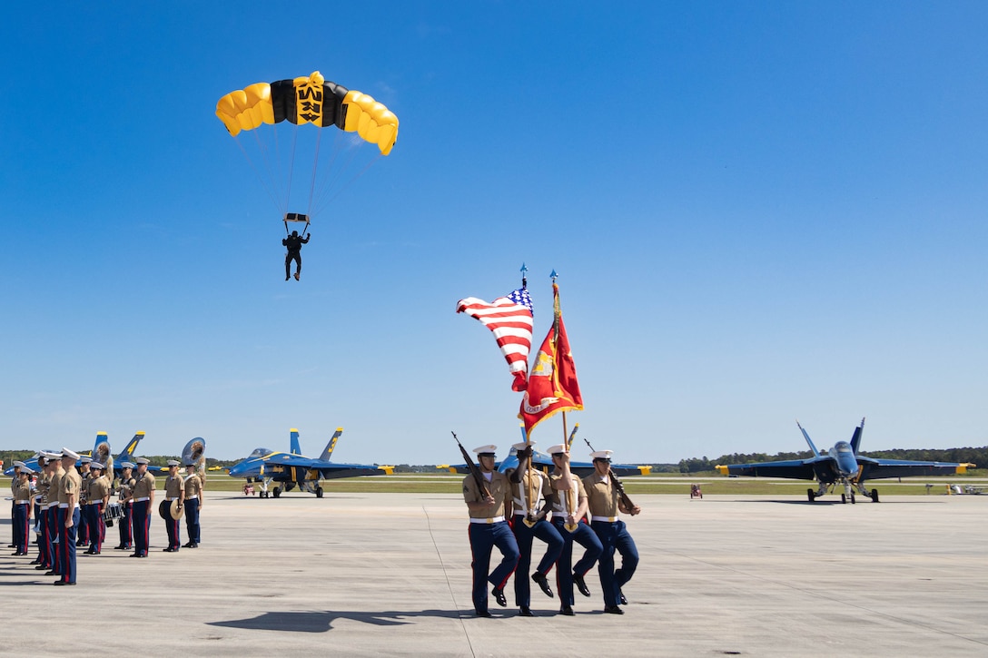 MCAS Beaufort 2025 Air Show opened with the U.S. Army Golden Knights parachute team egressing from the sky, the Parris Island Band, and U.S. Marines with the Marine Corps Air Station Beaufort color guard at Marine Corps Air Station Beaufort, South Carolina, April 13, 2025. Thousands of spectators travel to the Lowcountry to watch the air show, experience local food, and see aerial performances by military and civilian aircraft. (U.S. Marine Corps photo by Lance Cpl. Isabella Renaud)