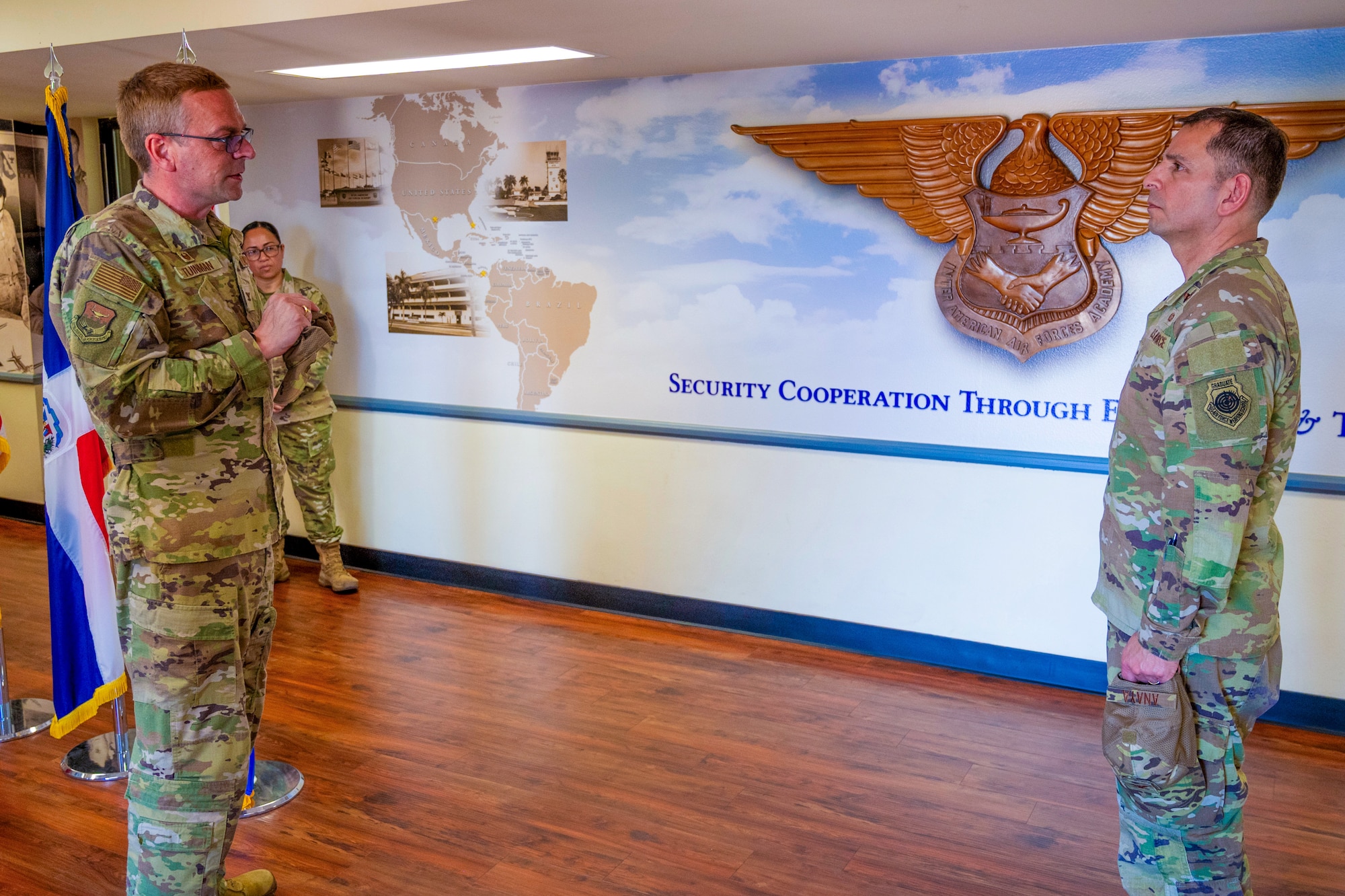 U.S. Air Force Col. Bryan Tuinman, Inter-American Air Forces Academy commander, left, Sergio Anaya, 62d Airlift Wing commander, discuss the IAAFA’s mission before a briefing at Joint Base San Antonio-Lackland, Texas, April 9, 2025.