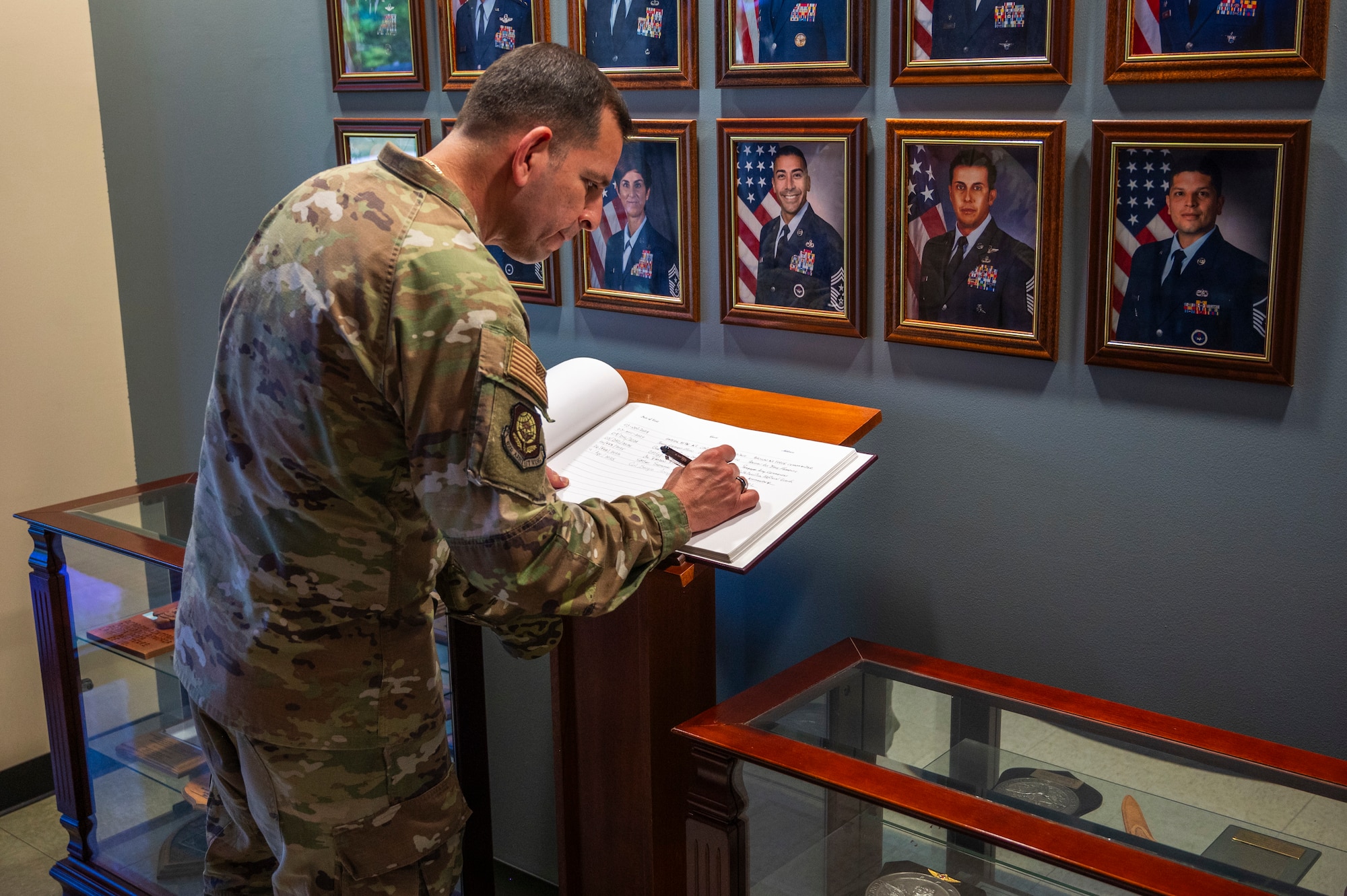 U.S. Air Force Col. Sergio Anaya, 62d Airlift Wing commander, signs the entryway visitor book in the 318th Training Squadron at the Inter-American Air Forces Academy at Joint Base San Antonio-Lackland, Texas, April 9, 2025.