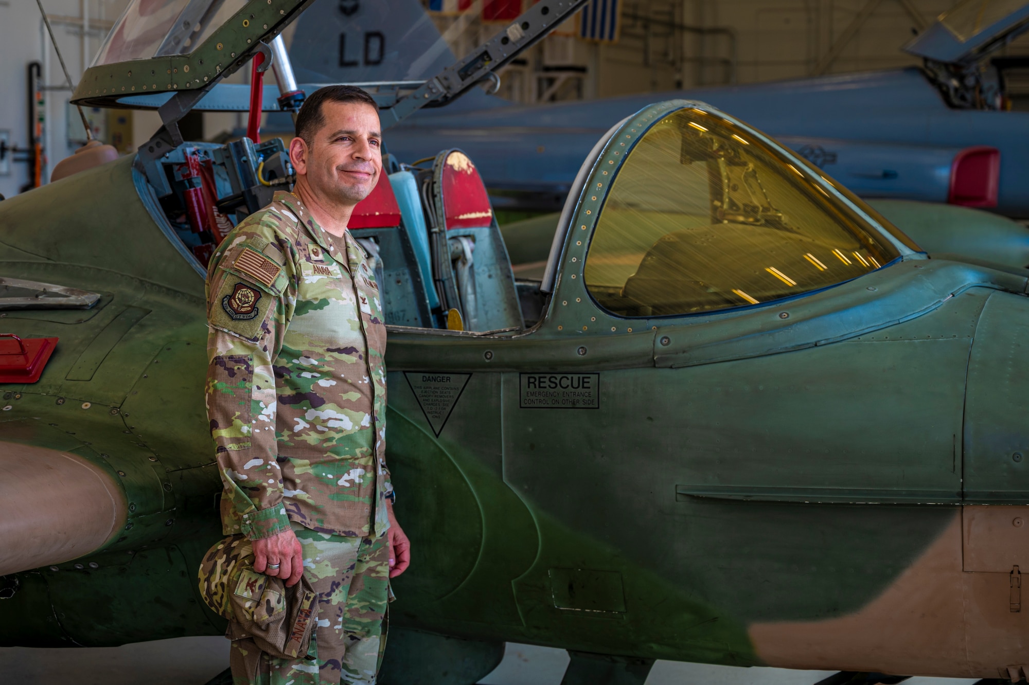 U.S. Air Force Col. Sergio Anaya, 62d Airlift Wing commander, stands next to a Cessna OA-37 Dragonfly while touring the Inter-American Air Forces Academy at Joint Base San Antonio-Lackland, Texas, April 9, 2025.