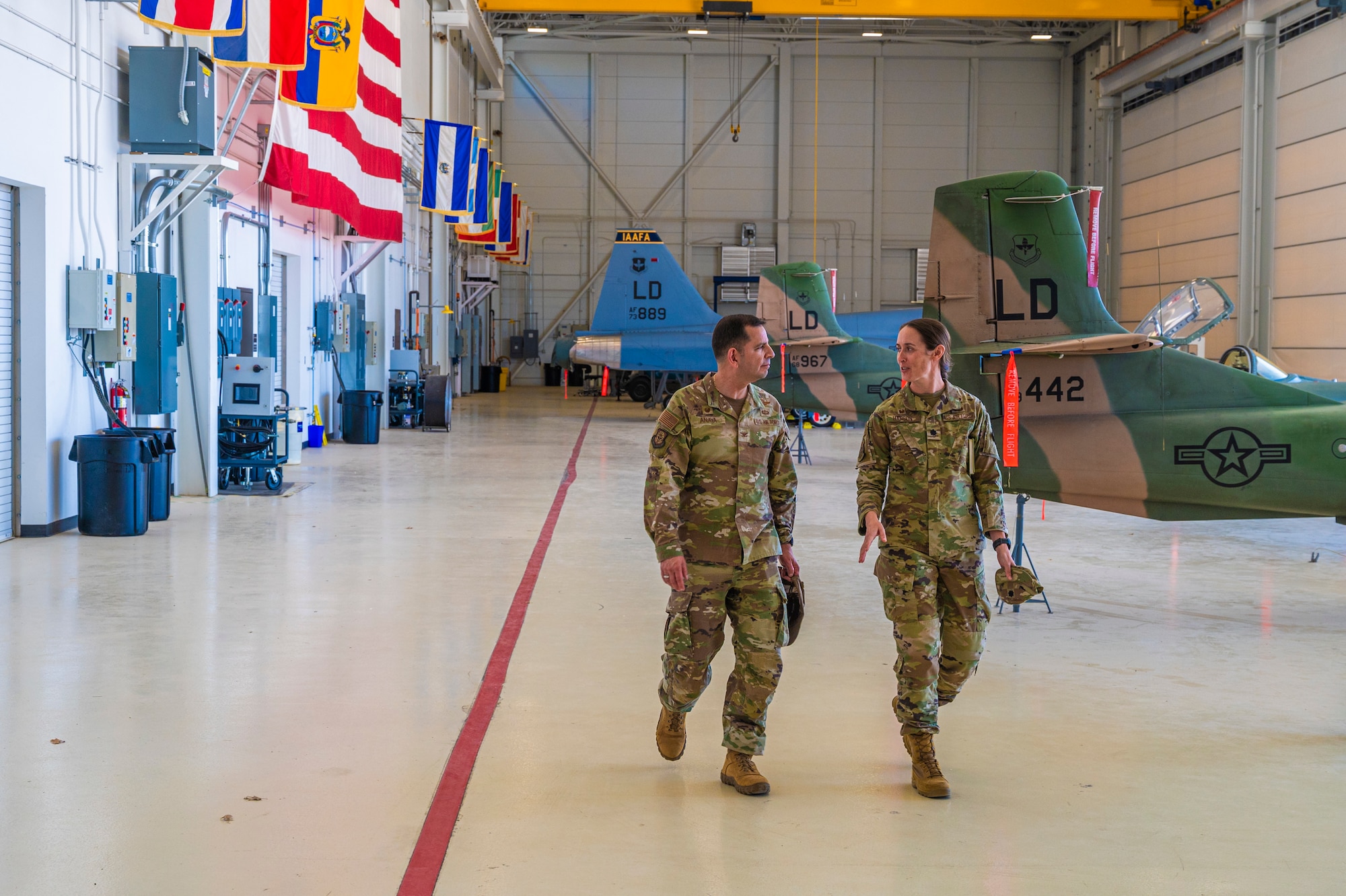 U.S. Air Force Col. Sergio Anaya, 62d Airlift Wing commander, left, and Lt. Col. Alexandra Hanson, 837th Training Squadron commander, talk while touring Inter-American Air Forces Academy facilities at Joint Base San Antonio-Lackland, Texas, April 9, 2025.