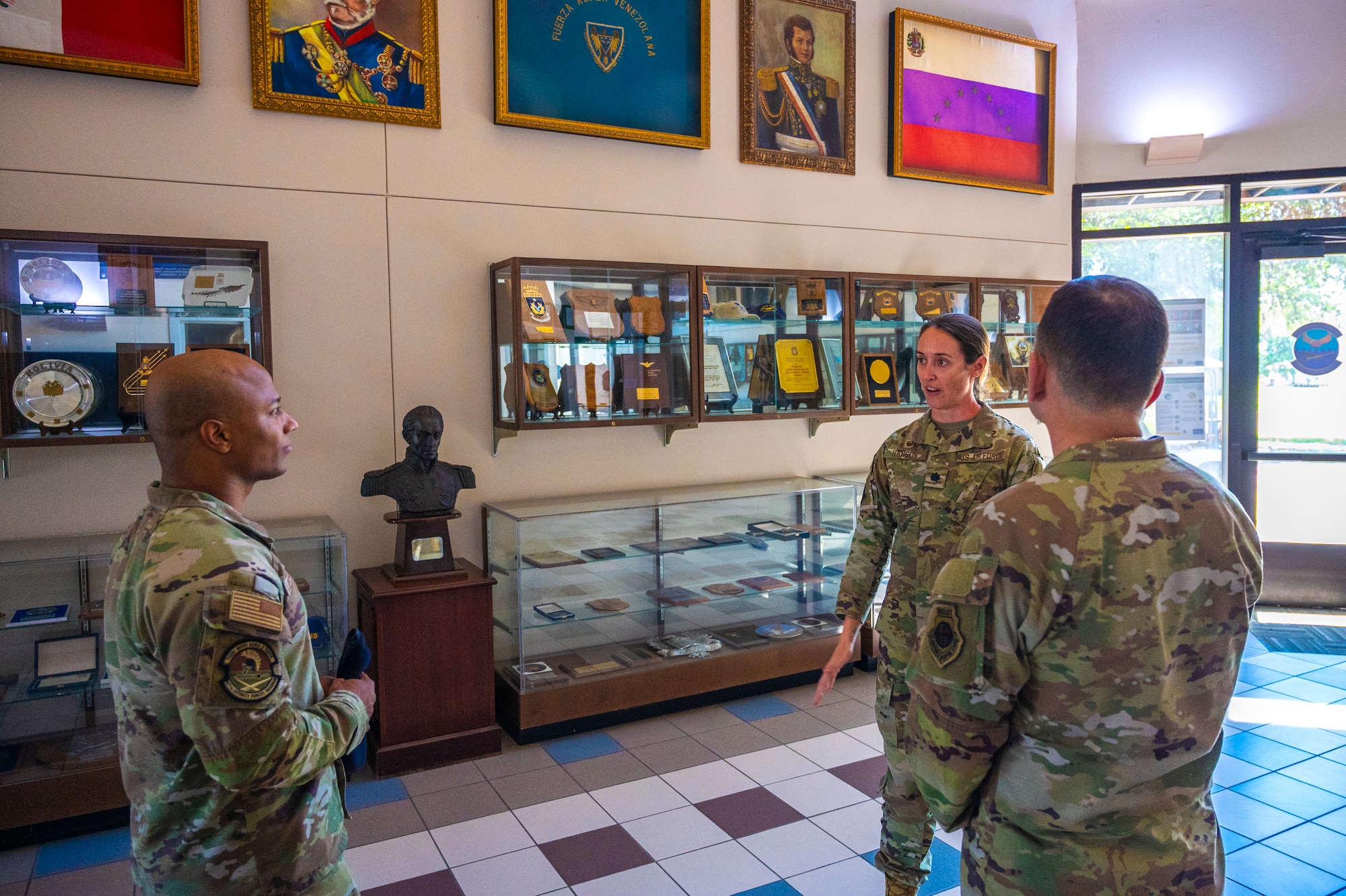 U.S. Air Force Col. Sergio Anaya, 62d Airlift Wing commander, right, Lt. Col. Alexandra Hanson, 837th Training Squadron commander, second from the right, and Master Sgt. José López Rodríguez, 627th Security Forces Squadron logistics and readiness superintendent, talk about the 837th TRS while touring Inter-American Air Forces Academy facilities at Joint Base San Antonio-Lackland, Texas, April 9, 2025.