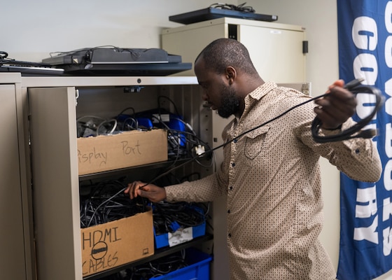 (250307-N-IX644-1047) FALLS CHURCH, Va. Modeste Mbamba, a native of Forestville, Maryland and a help desk technician in the Information Technology and Communication Services (ITACS) department, collects equipment for a user at Defense Health Headquarters in Falls Church, Virginia, March 7, 2025. For 250 years, Navy Medicine – represented by more than 44,000 highly-trained military and civilian health care professionals as well as experienced support staff – has delivered quality healthcare and enduring expeditionary medical support to the warfighter on, below, and above the sea and ashore. (U.S. Navy photo by Mass Communication Specialist 2nd Class Sasha Ambrose)