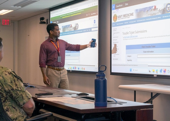 (250416-N-IX644-1012) FALLS CHURCH, Va. Tyrone Baugh, a native of Croton-on-Hudson, New York, and the senior help desk support lead in the Information Technology and Communication Services (ITACS) department, briefs Sailors in onboarding training at Defense Health Headquarters in Falls Church, Virginia, April 16, 2025. For 250 years, Navy Medicine – represented by more than 44,000 highly-trained military and civilian health care professionals as well as experienced support staff – has delivered quality healthcare and enduring expeditionary medical support to the warfighter on, below, and above the sea and ashore. (U.S. Navy photo by Mass Communication Specialist 2nd Class Sasha Ambrose)