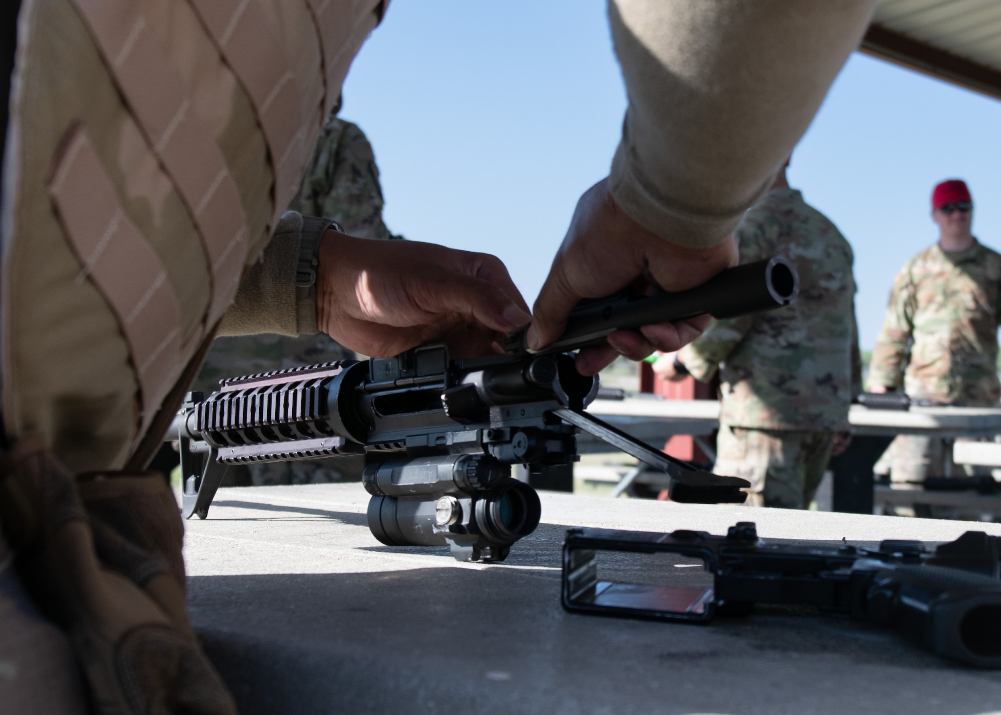 An Airman assigned to the 22nd Civil Engineer Squadron attaches a barrel to an M4 carbine during the 22nd CES Battle of the Bulls competition at McConnell Air Force Base, Kansas, April 17, 2025. Combat Arms Training and Maintenance instructors proctored the firearms-handling portion of the competition. (U.S. Air Force photo by Senior Airman Amelio Brown)