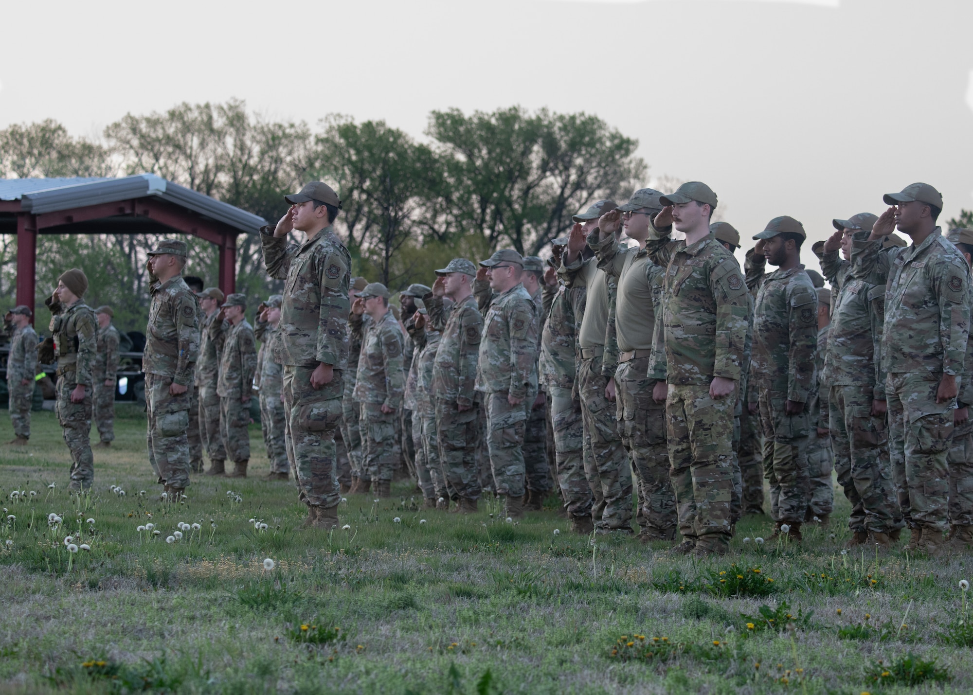 The 22nd Civil Engineer Squadron salutes for the national anthem during the 22nd CES Battle of the Bulls competition at McConnell Air Force Base, Kansas, April 17, 2025. The 22nd CES conducted a formation prior to officially kicking off the event. (U.S. Air Force photo by Senior Airman Amelio Brown)