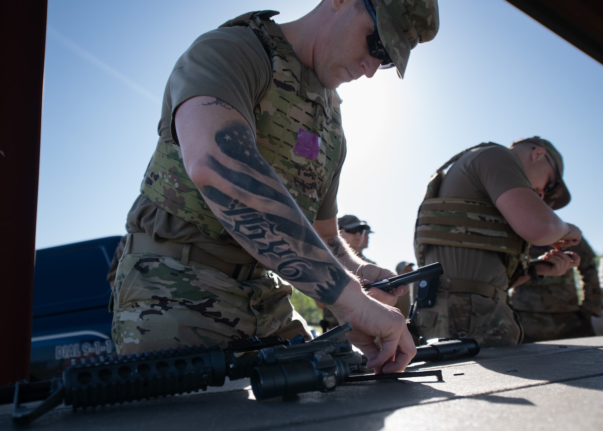 Tech. Sgt. Kyle Graber, 22nd Civil Engineer Squadron heating, ventilation and air conditioning technician, assembles an M4 carbine during the 22nd CES Battle of the Bulls competition at McConnell Air Force Base, Kansas, April 17, 2025. Each team participated in a challenge that consisted of disassembling, assembling, loading and clearing a rifle. (U.S. Air Force photo by Senior Airman Amelio Brown)