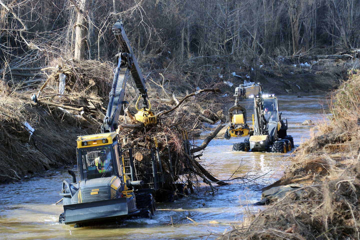 Contractors load waterway debris from the river near Azalea Park in Swannanoa North Carolina Feb. 1, 2025 where the waterway debris collection has begun in Buncombe County.