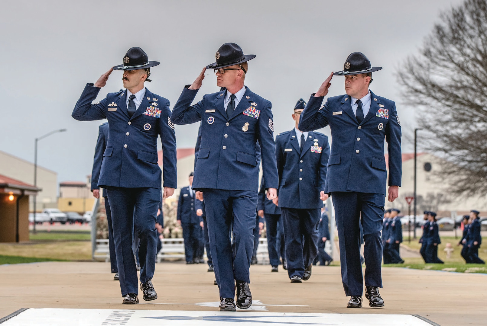 Air Force military training instructors lead formation of graduates at Air Force Officer Training School class 24-06 graduation parade.