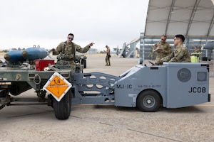 U.S. Air National Guard members assigned to the 162nd Wing gather for the annual Weapons Load Competition at Morris Air National Guard Base, Ariz., Apr. 4, 2025. Load Crew Chiefs were tested with a written portion in addition to loading the BDU-50, a 500-pound training munition. (U.S. Air National Guard photo by Tech. Sgt. Hampton Stramler)