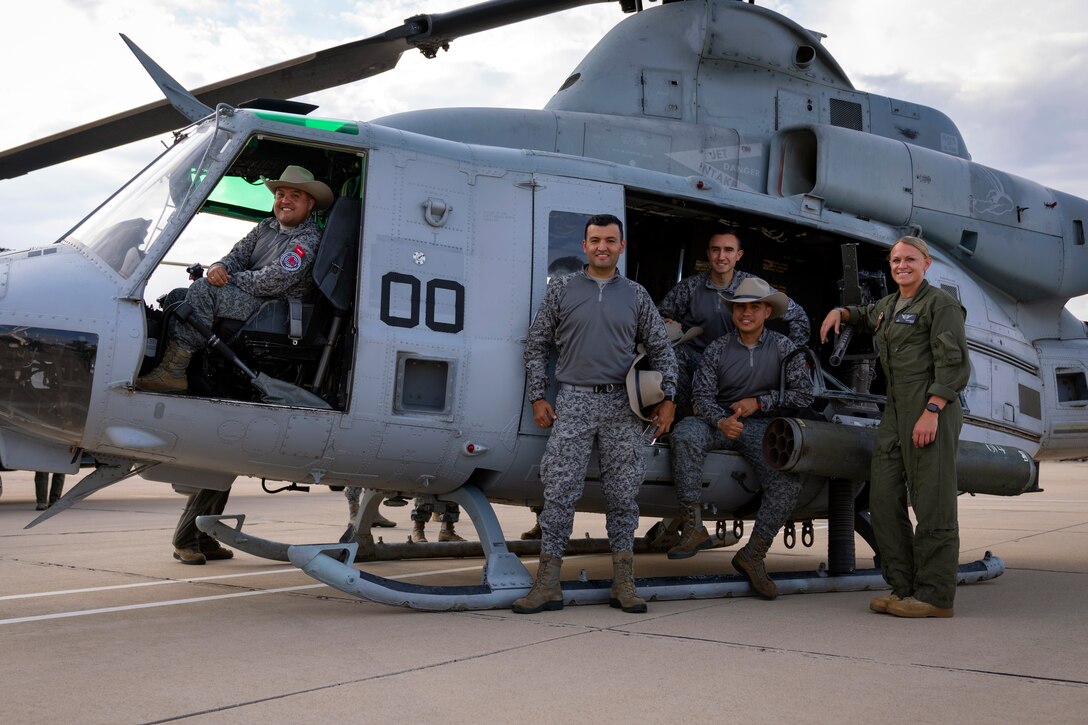 Colombian Air Force technicians and a U.S. Marine pose for a photo with a UH-1Y Venom helicopter during an exchange between Red Flag-Rescue 23-1 exercise participants at Davis-Monthan Air Force Base, Ariz., May 16, 2023. Exercises like Red Flag-Rescue present opportunities to build regional capacity with partner nations by enhancing cooperation, collaboration, and interoperability in a joint environment. (U.S. Air Force Photo by Tech. Sgt. Rachel Maxwell)