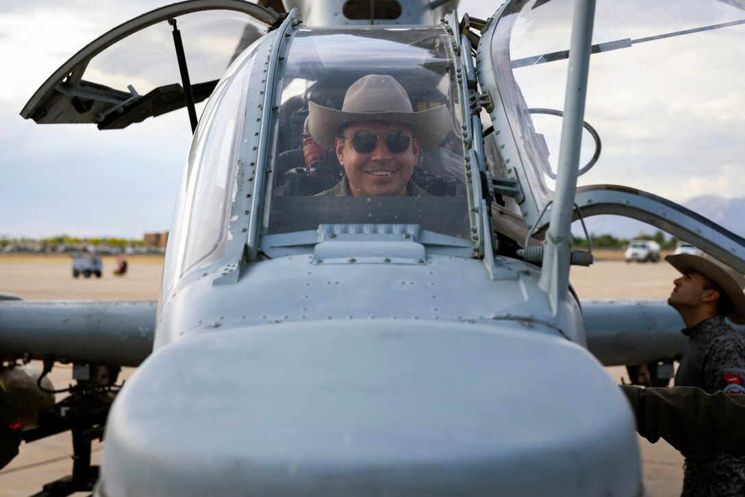 A Colombian Air Force aircrew member sists in the cockpit of a U.S. Marine Corps AH-1Z Viper helicopter during an exchange between Red Flag-Rescue 23-1 exercise participants at Davis-Monthan Air Force Base, Ariz., May 16, 2023. Exercises like Red Flag-Rescue present opportunities to build regional capacity with partner nations by enhancing cooperation, collaboration, and interoperability in a joint environment. (U.S. Air Force Photo by Tech. Sgt. Rachel Maxwell)